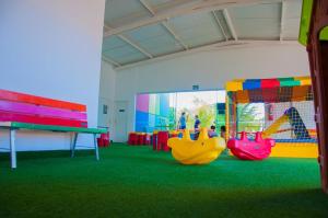 a play room with three swings and a slide at CAFÉ e ALMOÇO no LACQUA DIROMA Caldas Novas in Caldas Novas