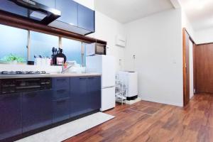 a kitchen with white appliances and a large window at 遊び庭-富士 in Funatsu