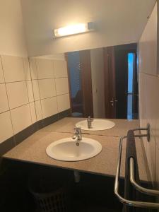 a bathroom with two sinks and a large mirror at Appartement T4 Standing Diégo-Suarez in Antsiranana +47 photos