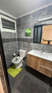 a bathroom with a toilet and a sink and a tub at Villa Mayana Studios ou chambre Business in Dzaoudzi +21 photos