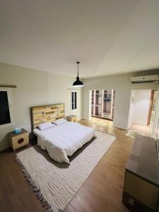 a large bedroom with a large bed and a flat screen tv at Mivida Emaar New Cairo For Rent in New cairo +18 photos