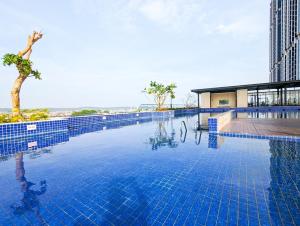 a large pool with blue tiles on the side of a building at Lovina 12- 20 at Pollux Meisterstadt in Batam Center