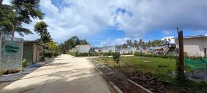 a street with houses and trees on the side at The Wings Boutique Hotels Krabi Ko Lanta in Ko Lanta