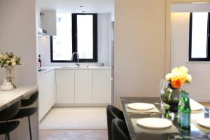 a kitchen and dining room with a table and chairs at Zhome Parkville-Three bedrooms with city view-Near Xin Tian Di in Shanghai +18 photos