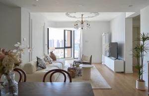 a living room with a couch and a tv at Eastern Hub - Bund Branch Near Yuyuan Garden Convenient Subway in Shanghai