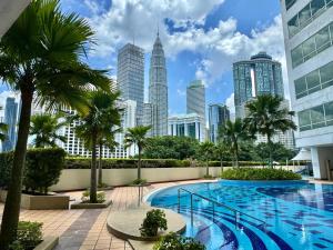 a pool in the middle of a city with tall buildings at HaBiBi hOmE Klcc in Kuala Lumpur