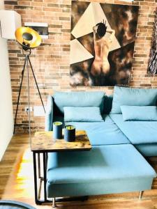 a living room with a blue couch and a table at Casa Torre San Lorenzo in Pisa