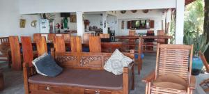 a bench with pillows on it in a restaurant at Kambuna Bungalow in Krui