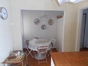 a dining room with a table and plates on the wall at Casa Monteprato in Zoagli