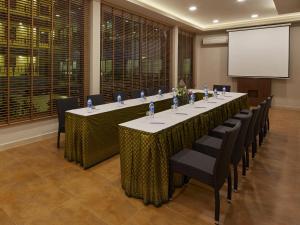 a conference room with a long table with chairs and a screen at The Agate Pattaya Boutique Resort in Pattaya South +77 photos