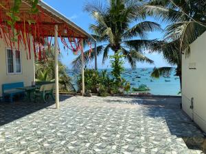 a resort patio with a view of the ocean at Homestay BONO Mũi Né in Phan Thiet