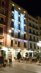 a large building with a christmas tree on it at Plaça De La Font in Tarragona