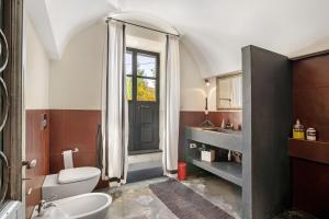 a bathroom with a toilet and a sink and a mirror at Villa Cangiani in Massa Lubrense +33 photos