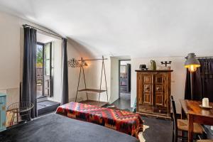a bedroom with a bed and a table and a desk at Villa Cangiani in Massa Lubrense