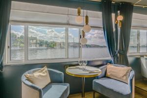 a room with a table and chairs and a window at Mälardrottningen Yacht Hotel in Stockholm