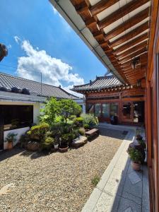 a courtyard with potted plants and a building at Yeonyijae hanok stay in Gyeongju