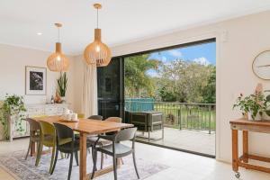 a kitchen and dining room with a table and chairs at Serenity at Salt - Beachside Beauty by uHoliday in Kingscliff