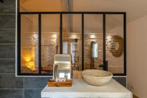 a bathroom with a large stone sink on a counter at Charmante maison en Arles : La Roquette in Arles