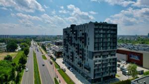 a tall building next to a street with a road at Zeus Apartments Lublin in Lublin