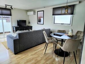 a living room with a couch and a table at Chalet V31 in Makkum
