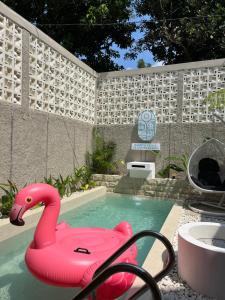 a pink flamingo float in a swimming pool at Sampai Villa Scandinavian in Yogyakarta