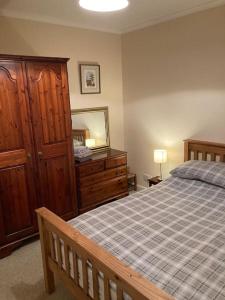 RhonddaにあるMaindy Lodgeのベッドとドレッサーと鏡のある寝室 +28枚の写真