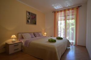 a bedroom with a bed with two green towels on it at Apartment Kuftic - Relax Zone - Quiet Street in Rovinj