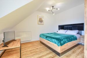 Łóżko lub łóżka w pokoju w obiekcie Westa Apartamenty