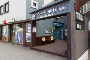 a store front with two chairs on a wooden deck at EKonomy Hotel Incheon Bupyeong Branch in Incheon
