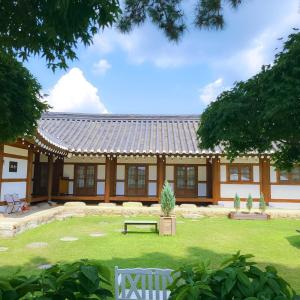 a building with a park in front of it at Yeongam Haeden Hanok Stay in Yeongam