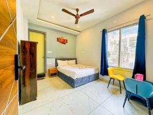 a bedroom with a bed and a ceiling fan at Devlok Homes in Rishīkesh