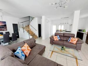 a living room with two couches and a dining room at Casa Palma by Rental Hero in Los Alcázares