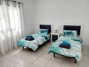 two beds sitting next to each other in a room at Casa Palma by Rental Hero in Los Alcázares