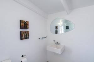 a white bathroom with a sink and a mirror at Dreamcatcher Lavender in Paternoster +5 photos