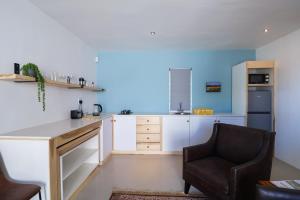a kitchen with a desk and a chair at Dreamcatcher Rosemary in Paternoster