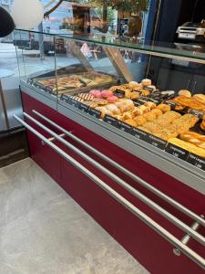a display case filled with lots of different types of donuts at Stadtpension Heilbronn in Heilbronn +24 photos
