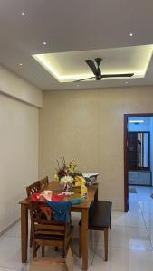 a dining room with a table and chairs and a ceiling at PENT HOUSE, Willows Apartments, Neermarga, Mangalore in Mangalore