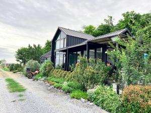 a black house with glass windows and a driveway at Fulfield Cafe&Resort in Ban Wang Wa (1)