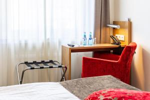 Cama ou camas em um quarto em Maingau Hotel