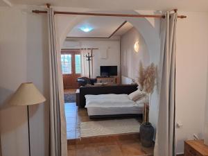 a living room with a bed and a couch at Apartman Romana in Poštorná