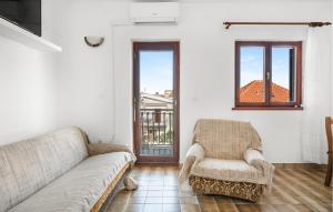 a living room with a couch and a chair at Nice Apartment In Sibenik With Wifi in Šibenik
