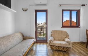 a living room with a couch and a chair at Nice Apartment In Sibenik With Wifi in Šibenik