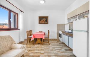 a kitchen and dining room with a table and a couch at Nice Apartment In Sibenik With Wifi in Šibenik
