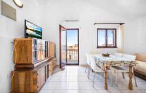 a living room with a dining room table and a television at Awesome Apartment In Sibenik With Wifi in Šibenik