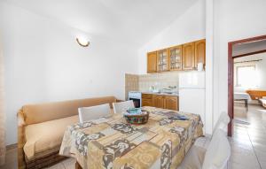 a kitchen and dining room with a table and chairs at Awesome Apartment In Sibenik With Wifi in Šibenik
