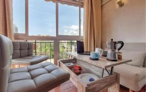 a living room with a couch and a table at Pet Friendly Apartment In Torremolinos in Torremolinos