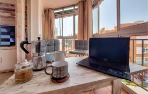 a laptop computer sitting on a wooden table in a room at Pet Friendly Apartment In Torremolinos in Torremolinos