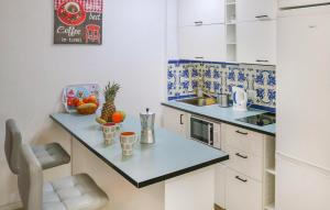 a small kitchen with a counter with fruits on it at Pet Friendly Apartment In Torremolinos in Torremolinos
