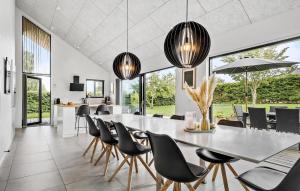 HejlsにあるCozy Home In Hejls With Saunaのダイニングルーム(大きなテーブル、椅子付)