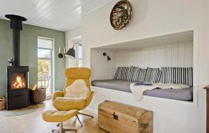 a bedroom with a bed and a chair and a fireplace at Cozy Home In Odder With Wifi in Odder